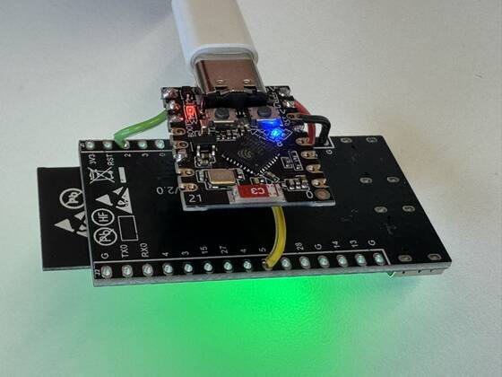An ESP32-C5 development board with an ESP32-C3 wired on top as the Wi-Fi gateway